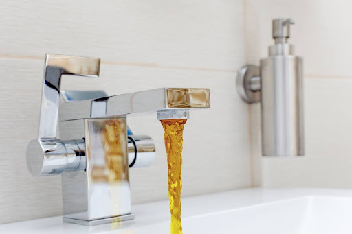 Rusty water coming out of a sink faucet.