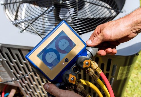 A technician performing a service on an outdoor AC unit.